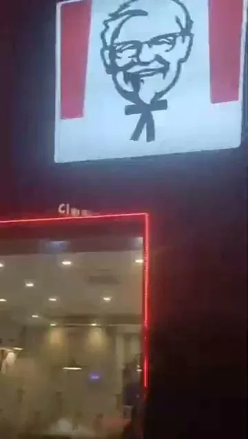 KFC storefront sign lit up at night, one of the merchants a Novaluxia points voucher can be redeemed at