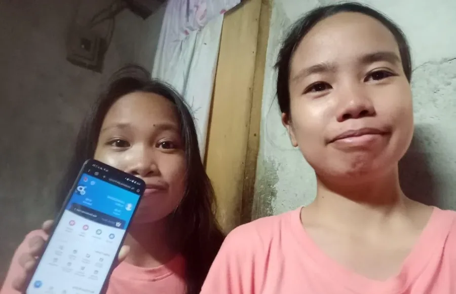 Two Philippine shoppers taking a selfie with a phone on the Novaluxia app account screen